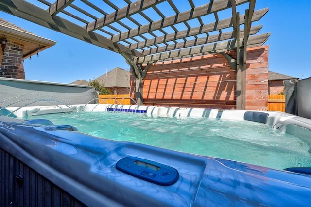 view of pool featuring fence, a pergola, and a hot tub