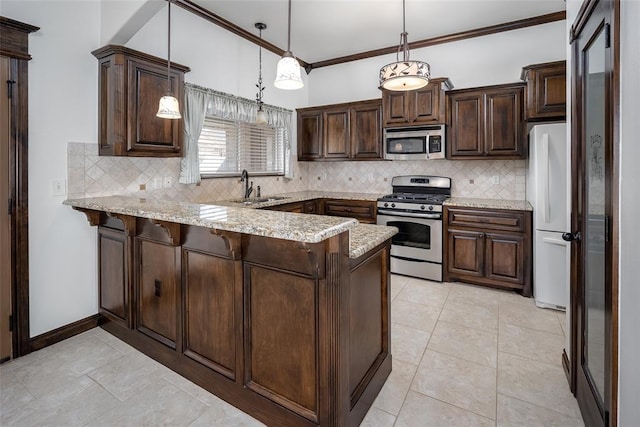 kitchen featuring a sink, appliances with stainless steel finishes, a peninsula, and dark brown cabinets