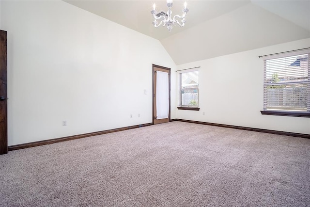 carpeted spare room with lofted ceiling, plenty of natural light, baseboards, and a chandelier