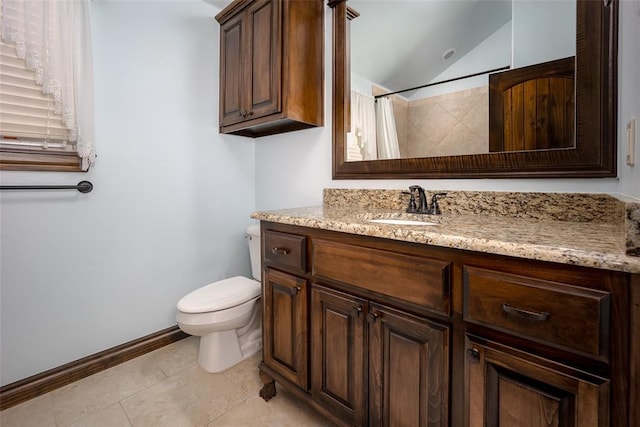 bathroom featuring toilet, lofted ceiling, tile patterned flooring, baseboards, and vanity