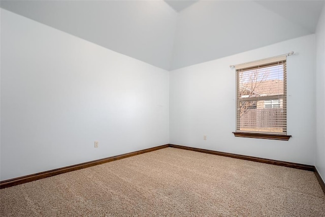 carpeted empty room featuring baseboards