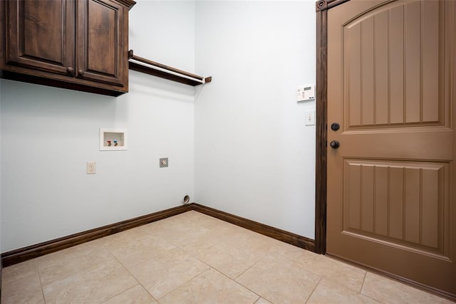 laundry room featuring hookup for a washing machine, light tile patterned floors, baseboards, cabinet space, and electric dryer hookup