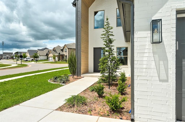 8101 Jenny Ln, Edmond, OK 73034 - view of side of property with a residential view, a lawn, and brick siding