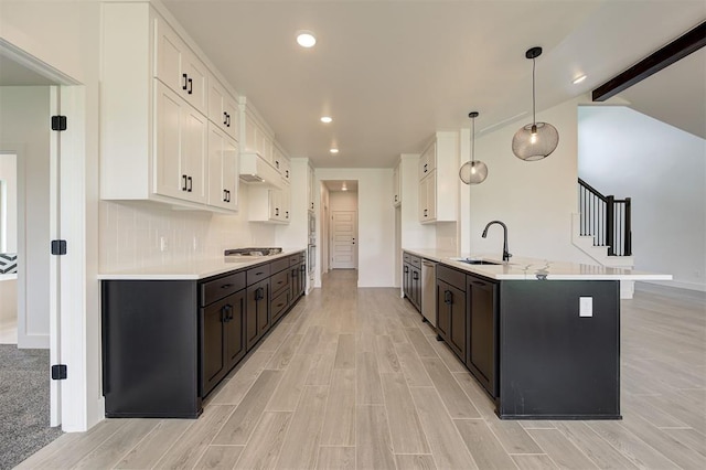 8101 Jenny Ln, Edmond, OK 73034 - kitchen featuring white cabinets, a sink, appliances with stainless steel finishes, light countertops, and light wood-type flooring