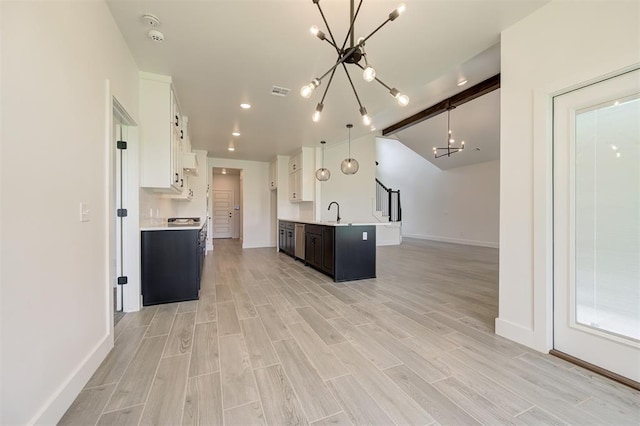 8101 Jenny Ln, Edmond, OK 73034 - kitchen with a chandelier, light countertops, baseboards, white cabinets, and open floor plan