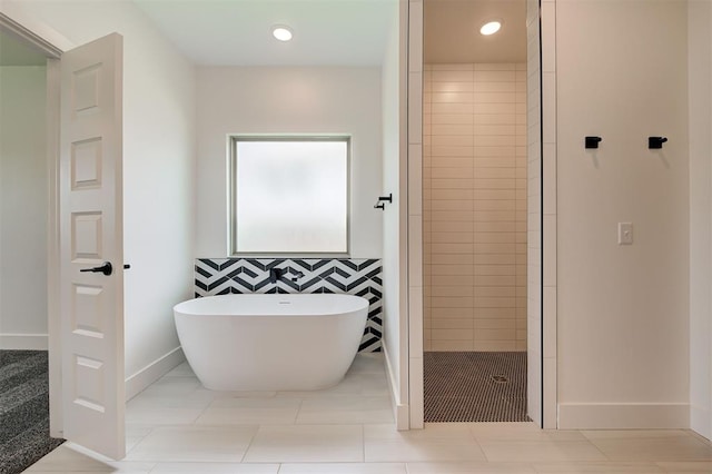 8101 Jenny Ln, Edmond, OK 73034 - bathroom with a freestanding bath, a tile shower, baseboards, and recessed lighting
