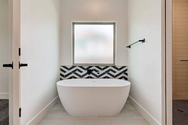 8101 Jenny Ln, Edmond, OK 73034 - bathroom featuring a freestanding bath, a tile shower, baseboards, and tile patterned floors