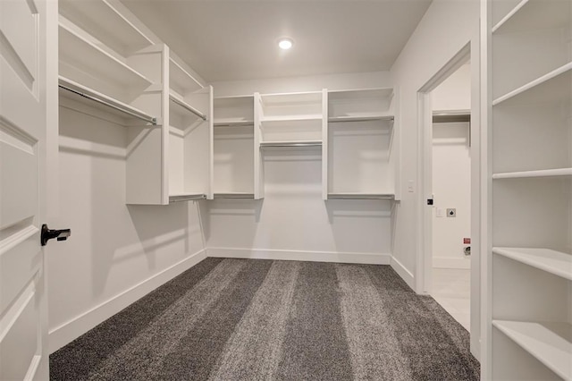 8101 Jenny Ln, Edmond, OK 73034 - walk in closet featuring dark colored carpet