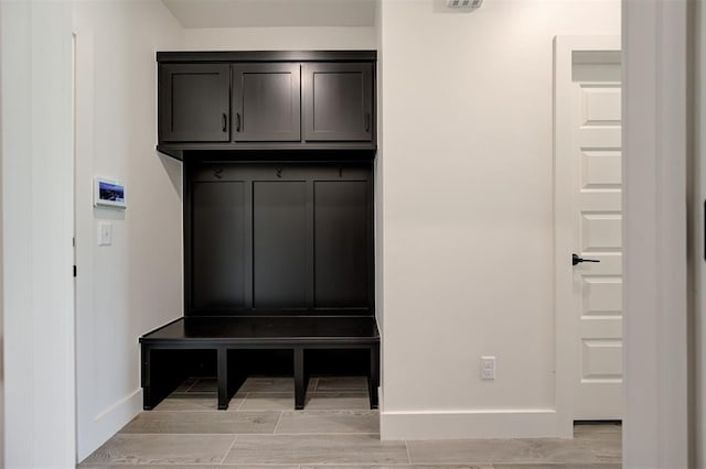 8101 Jenny Ln, Edmond, OK 73034 - mudroom featuring baseboards and wood tiled floors