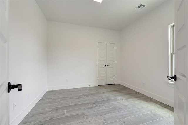 8101 Jenny Ln, Edmond, OK 73034 - spare room featuring baseboards and light wood-style flooring