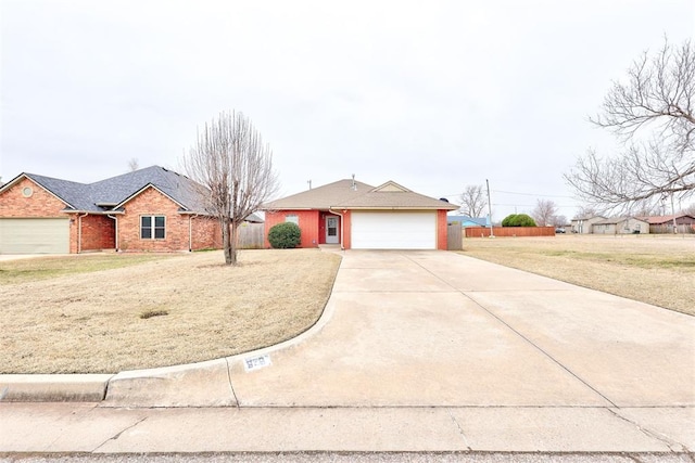 ranch-style house featuring concrete driveway, fence, a garage, and a front yard