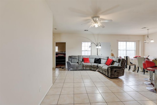 636 NW 112th St, Oklahoma City, OK 73114 - living room featuring light tile patterned floors, visible vents, and ceiling fan with notable chandelier