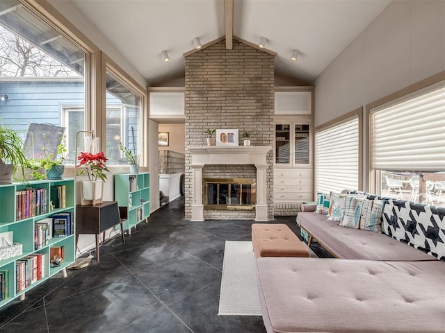 living area with lofted ceiling with beams and a fireplace