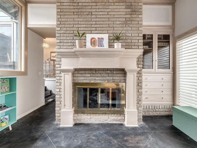 details featuring a brick fireplace and baseboards