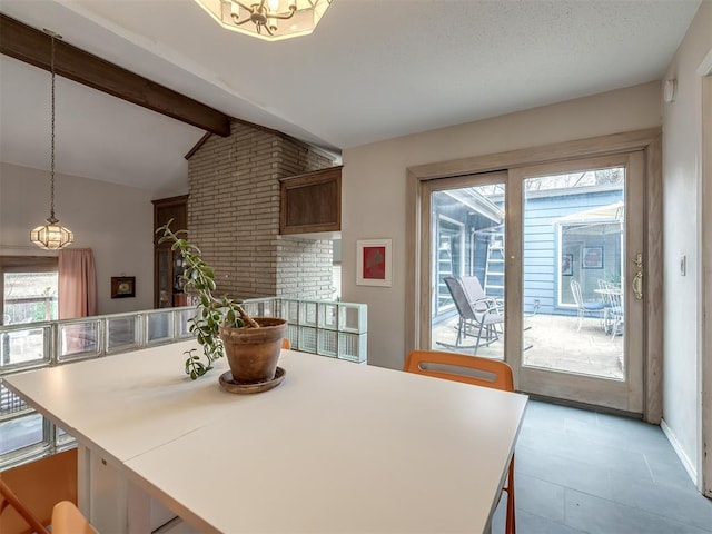 dining room featuring vaulted ceiling with beams