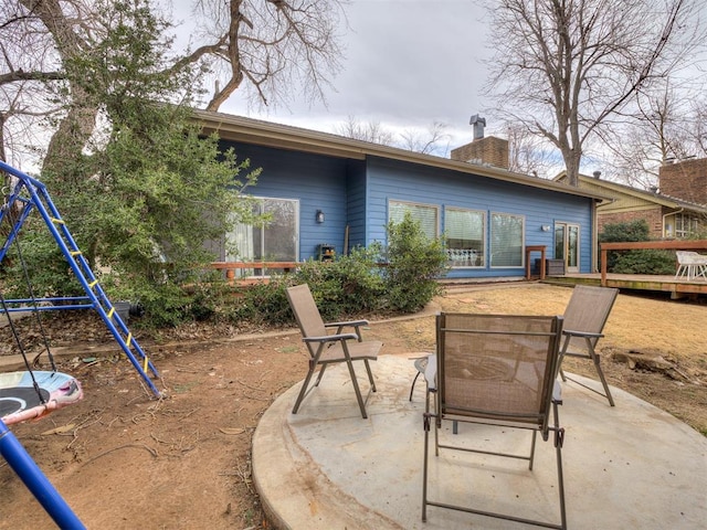 rear view of house with a patio and a chimney