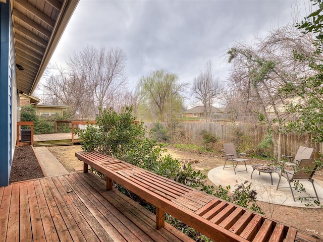 wooden terrace with a patio area and a fenced backyard