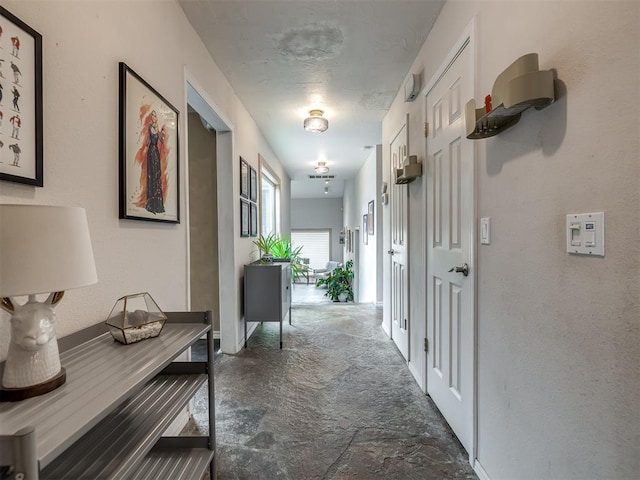 corridor featuring stone finish flooring