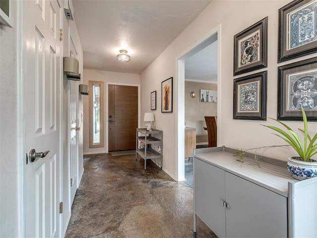 entryway with concrete flooring and baseboards