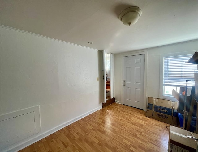 entrance foyer with light wood-type flooring and baseboards