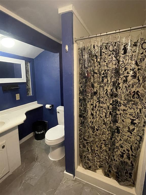 bathroom with vanity, baseboards, a stall shower, toilet, and marble finish floor