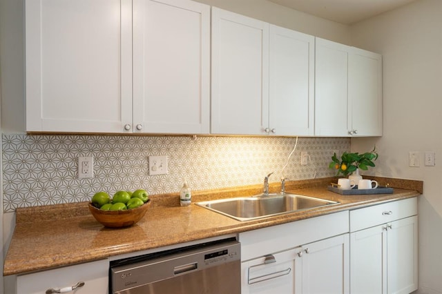 kitchen with a sink, stainless steel dishwasher, and white cabinets