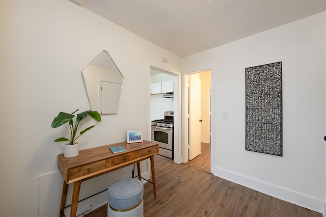 office space with wood finished floors, baseboards, and a textured ceiling