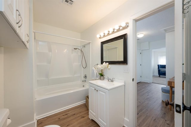 full bathroom featuring visible vents, toilet, shower / bath combination, wood finished floors, and vanity