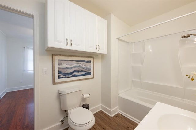 full bath featuring toilet, shower / bathing tub combination, baseboards, and wood finished floors