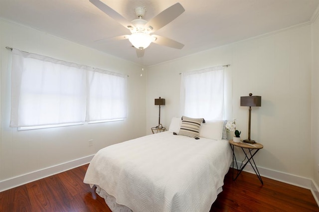 bedroom featuring a ceiling fan, wood finished floors, and baseboards