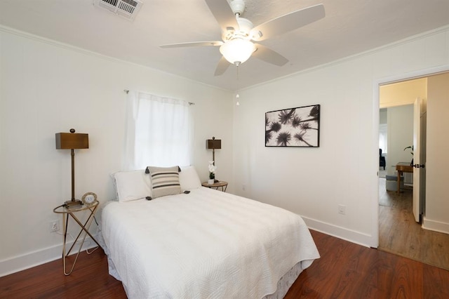 bedroom featuring crown molding, wood finished floors, and visible vents