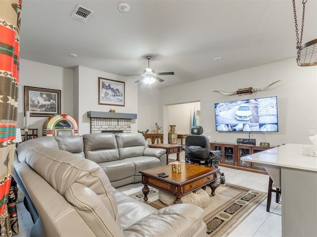 living area with a fireplace, a ceiling fan, and visible vents