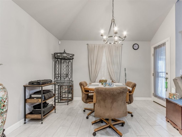 dining space with lofted ceiling, light wood-style flooring, a notable chandelier, and baseboards