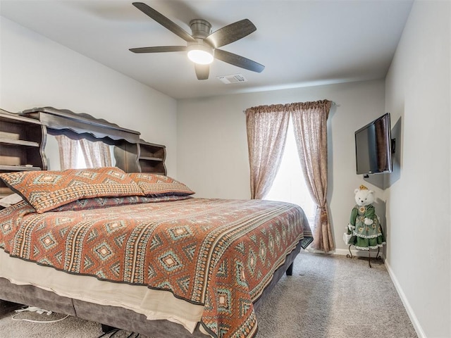 bedroom with carpet flooring, baseboards, visible vents, and ceiling fan