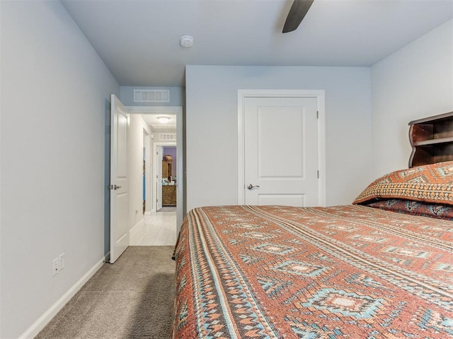 carpeted bedroom featuring a ceiling fan, baseboards, and visible vents