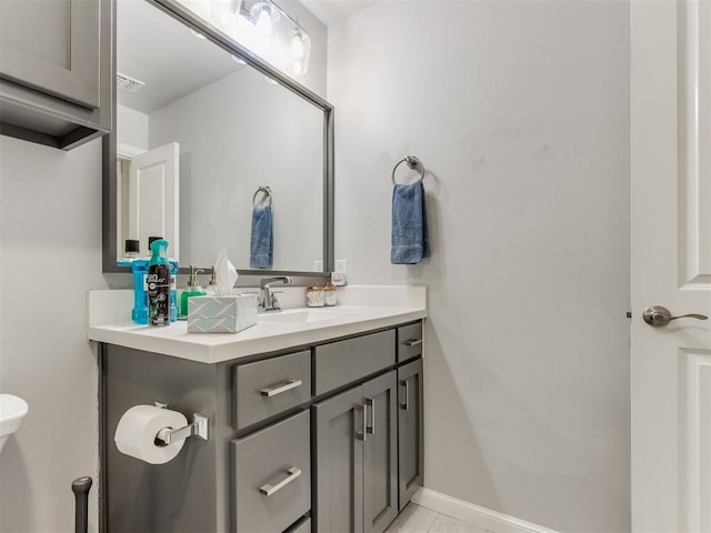 bathroom featuring baseboards and vanity