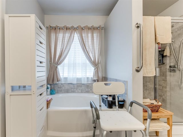 bathroom featuring a garden tub and a tile shower