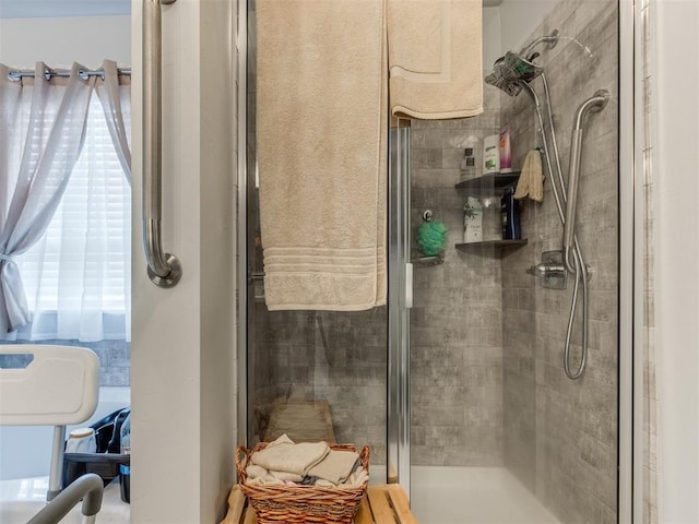 bathroom featuring a wealth of natural light and a stall shower