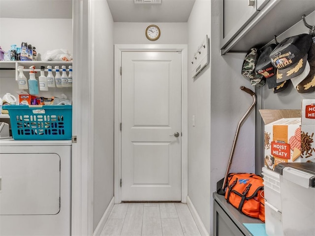 interior space featuring visible vents, washer / clothes dryer, baseboards, and laundry area