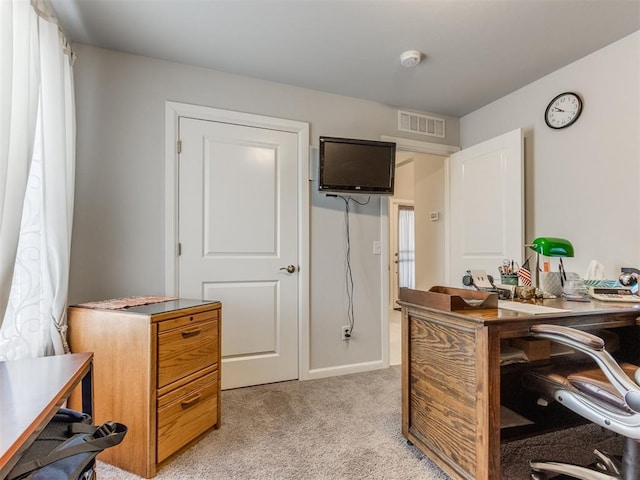 home office with baseboards, visible vents, and light carpet