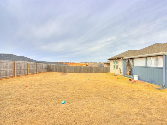 view of yard with a fenced backyard