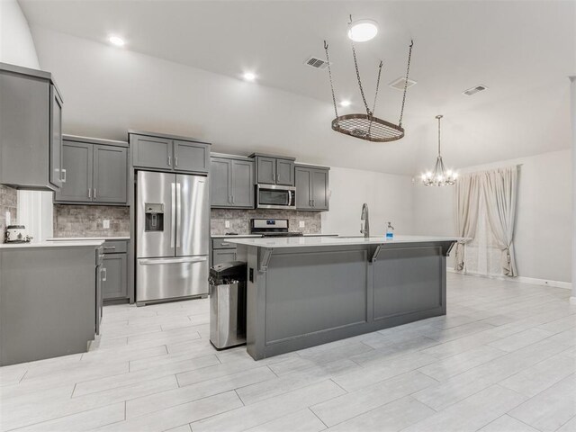294 Emmy Jean Dr, Blanchard, OK 73010 - kitchen with gray cabinets, appliances with stainless steel finishes, tasteful backsplash, and light countertops