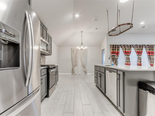 294 Emmy Jean Dr, Blanchard, OK 73010 - kitchen with a sink, a notable chandelier, light countertops, appliances with stainless steel finishes, and hanging light fixtures