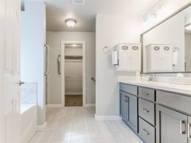 294 Emmy Jean Dr, Blanchard, OK 73010 - full bath featuring baseboards, vanity, a walk in closet, and a stall shower