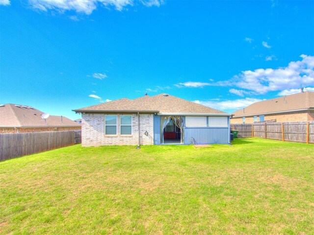 294 Emmy Jean Dr, Blanchard, OK 73010 - back of property featuring a fenced backyard, brick siding, and a yard