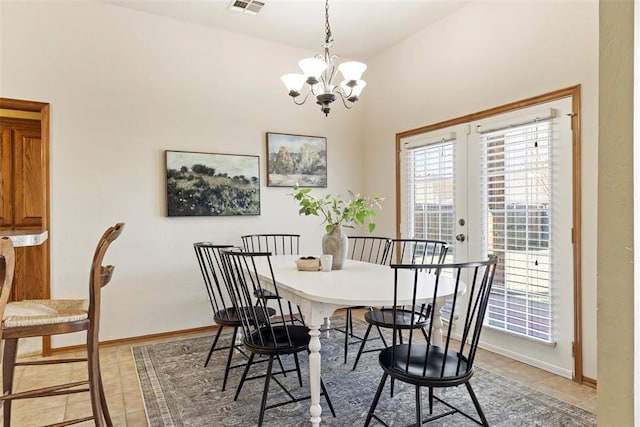 dining room with light tile patterned flooring, visible vents, baseboards, and an inviting chandelier