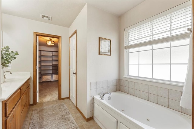 bathroom featuring vanity, visible vents, a closet, tile patterned floors, and a jetted tub