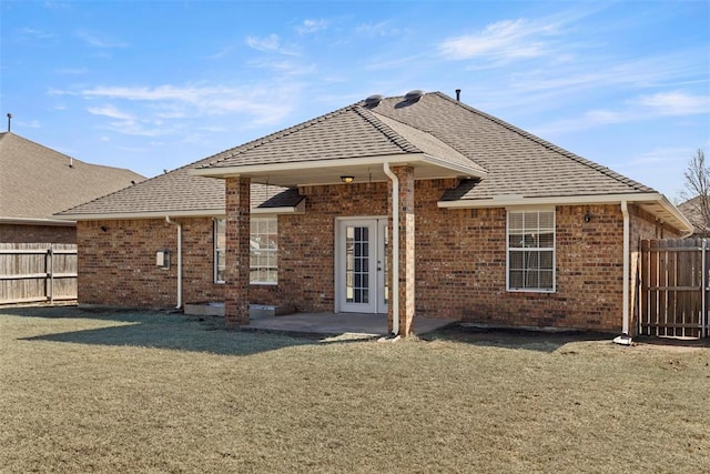 back of property featuring a patio, a yard, fence, and brick siding