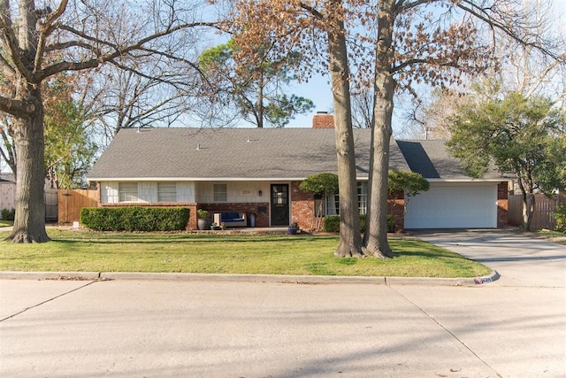 ranch-style home featuring a front lawn, an attached garage, a chimney, and fence