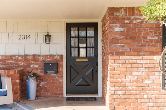 property entrance with brick siding